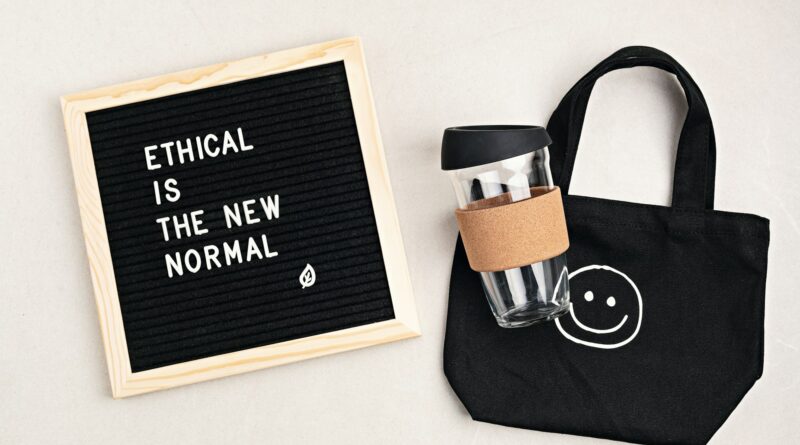 Ethical is the new normal letterboard text. Black organic cotton eco bag and reusable coffee cup